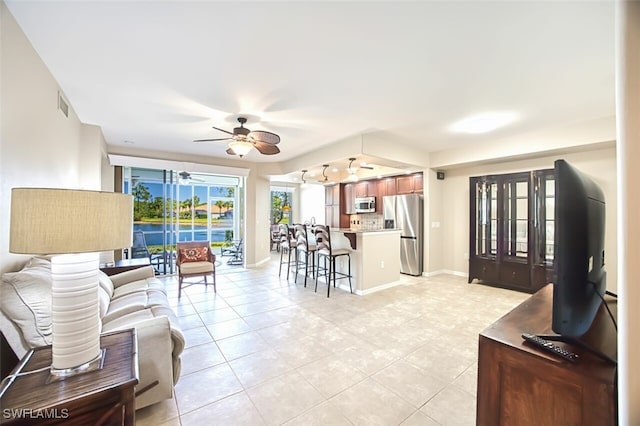 11029 Mill Creek Way Unit 406, Fort Myers, FL 33913 - living area with ceiling fan and light tile patterned flooring