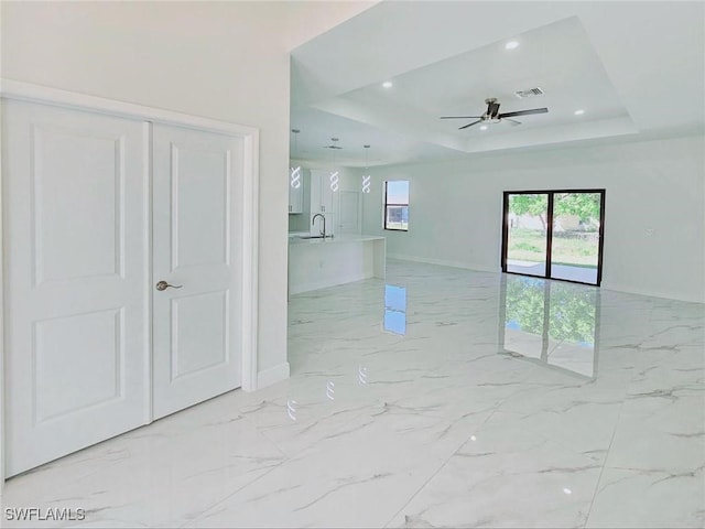 3400 23rd St W, Lehigh Acres, FL 33971 - spare room with a ceiling fan, visible vents, baseboards, and a raised ceiling