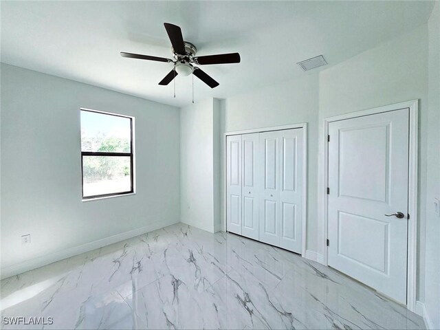 3400 23rd St W, Lehigh Acres, FL 33971 - unfurnished bedroom featuring visible vents, a closet, marble finish floor, baseboards, and ceiling fan