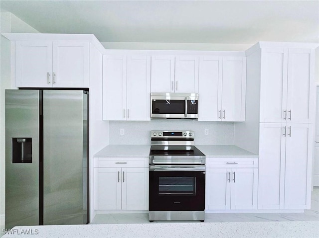 3400 23rd St W, Lehigh Acres, FL 33971 - kitchen featuring white cabinets, stainless steel appliances, and light countertops