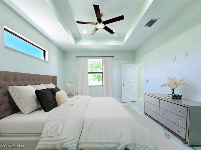 3400 23rd St W, Lehigh Acres, FL 33971 - bedroom with visible vents, marble finish floor, baseboards, a tray ceiling, and a ceiling fan