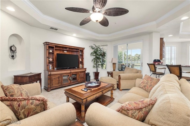 living area with recessed lighting, ornamental molding, ceiling fan, visible vents, and a tray ceiling