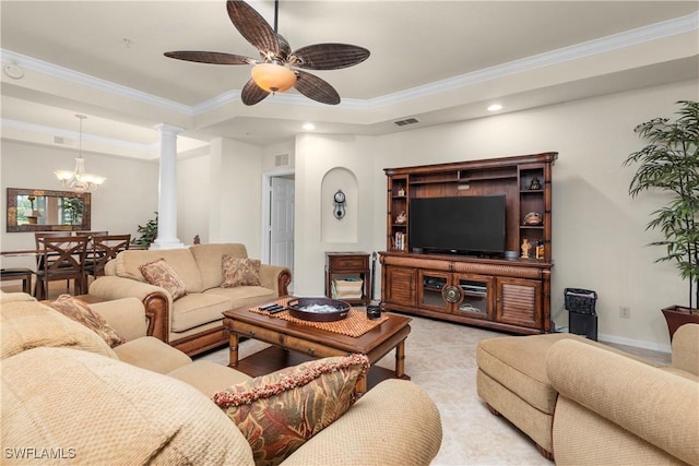 living area featuring ornate columns, a raised ceiling, ceiling fan with notable chandelier, and crown molding