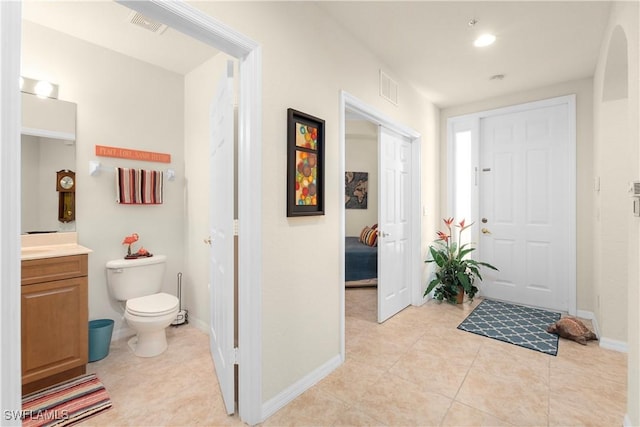 entryway featuring light tile patterned floors, visible vents, and baseboards