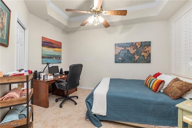 bedroom featuring ornamental molding, ceiling fan, and a tray ceiling