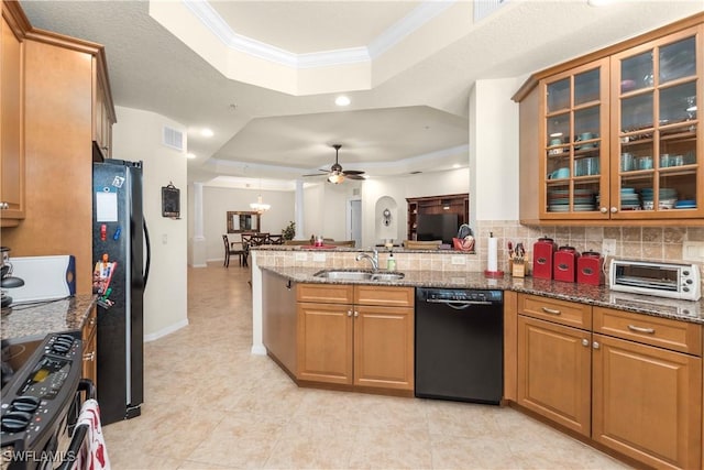 kitchen with ornamental molding, black appliances, a sink, a raised ceiling, and a peninsula