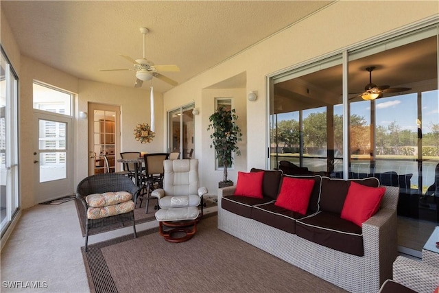 sunroom with outdoor lounge area and ceiling fan