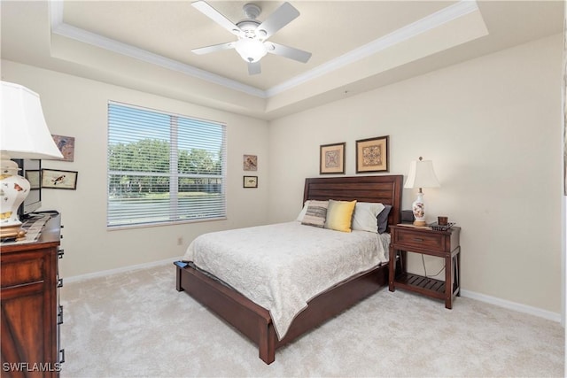 bedroom with ceiling fan, a raised ceiling, light carpet, baseboards, and ornamental molding
