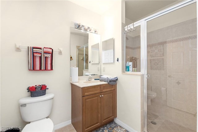 bathroom with toilet, a stall shower, vanity, and baseboards