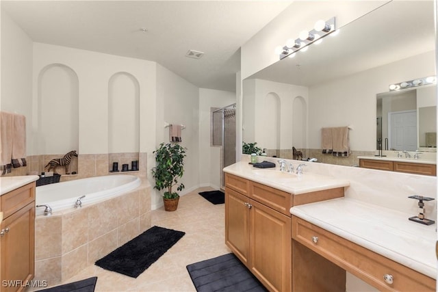 bathroom with tile patterned flooring, a shower stall, vanity, visible vents, and a garden tub