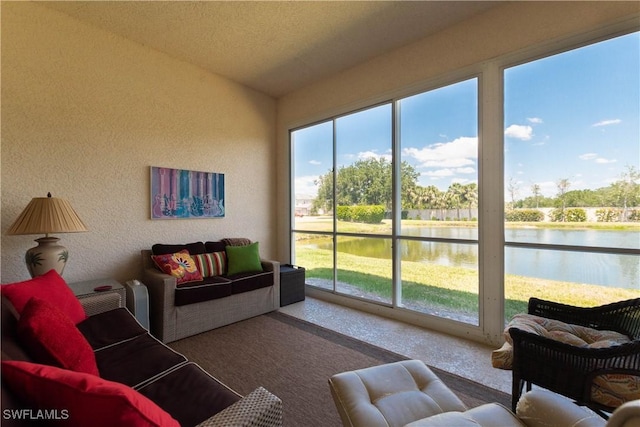 sunroom / solarium featuring a water view