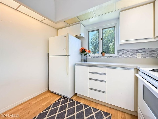 1632 Spoonbill Ln Unit B, Naples, FL 34105 - kitchen with white appliances, light countertops, white cabinets, light wood-style floors, and backsplash