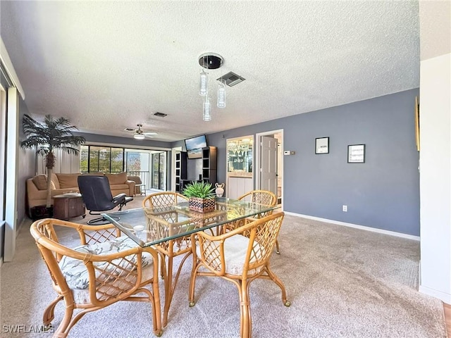 1632 Spoonbill Ln Unit B, Naples, FL 34105 - carpeted dining room featuring a textured ceiling, ceiling fan, and baseboards