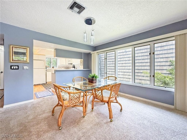 1632 Spoonbill Ln Unit B, Naples, FL 34105 - dining area featuring baseboards, light colored carpet, and a textured ceiling