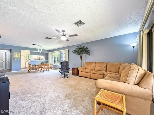 1632 Spoonbill Ln Unit B, Naples, FL 34105 - carpeted living area featuring a ceiling fan, a textured ceiling, and baseboards