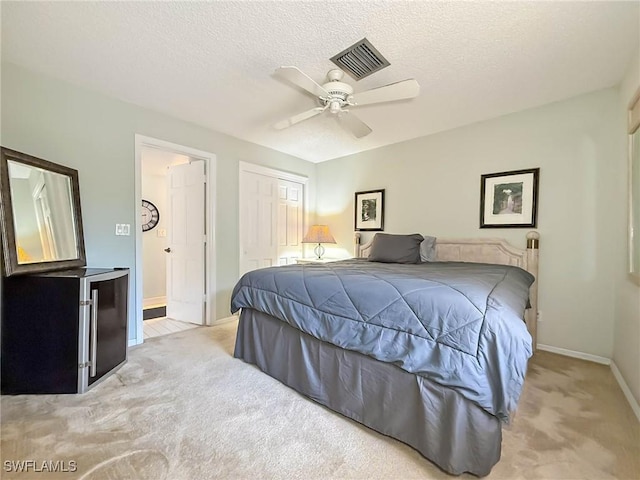 1632 Spoonbill Ln Unit B, Naples, FL 34105 - bedroom featuring carpet floors, baseboards, a closet, ceiling fan, and a textured ceiling