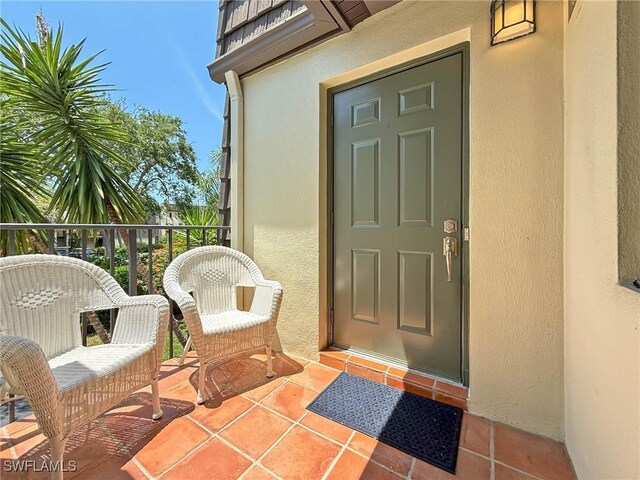 1632 Spoonbill Ln Unit B, Naples, FL 34105 - entrance to property featuring stucco siding and a balcony