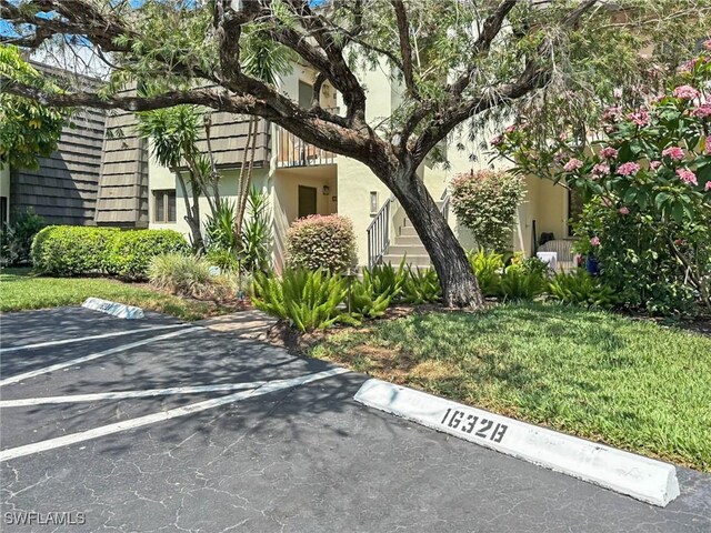1632 Spoonbill Ln Unit B, Naples, FL 34105 - view of side of property with uncovered parking and stucco siding
