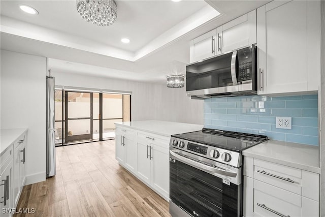 517 Lake Louise Cir Unit 101, Naples, FL 34110 - kitchen featuring appliances with stainless steel finishes, light wood-style flooring, tasteful backsplash, light countertops, and recessed lighting
