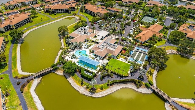 517 Lake Louise Cir Unit 101, Naples, FL 34110 - drone / aerial view of a pool and a nearby body of water