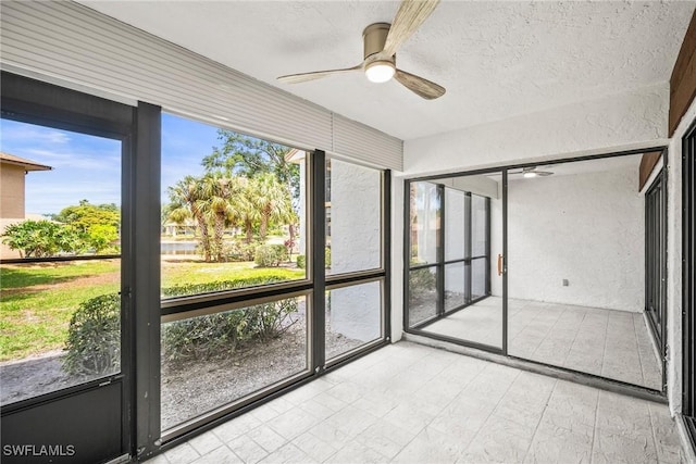 517 Lake Louise Cir Unit 101, Naples, FL 34110 - unfurnished sunroom featuring a ceiling fan