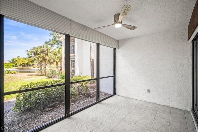 517 Lake Louise Cir Unit 101, Naples, FL 34110 - unfurnished sunroom with ceiling fan and a water view