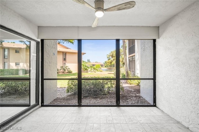517 Lake Louise Cir Unit 101, Naples, FL 34110 - unfurnished sunroom with ceiling fan and plenty of natural light