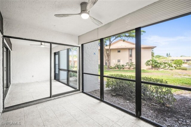 517 Lake Louise Cir Unit 101, Naples, FL 34110 - unfurnished sunroom featuring ceiling fan