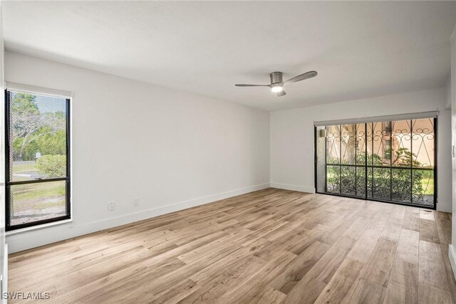 517 Lake Louise Cir Unit 101, Naples, FL 34110 - empty room with light wood-style floors, ceiling fan, and baseboards
