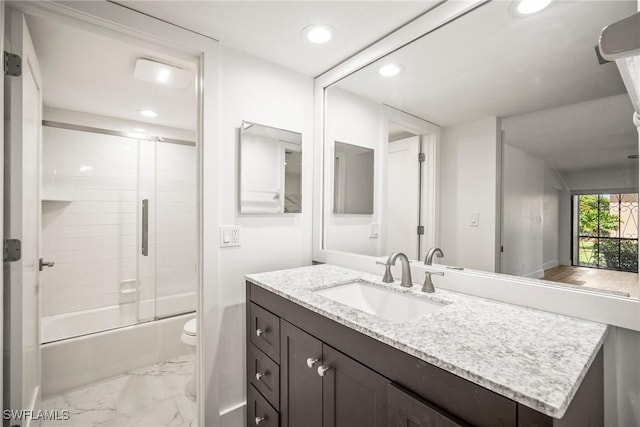 517 Lake Louise Cir Unit 101, Naples, FL 34110 - bathroom with toilet, vanity, marble look tile flooring, recessed lighting, and combined bath / shower with glass door