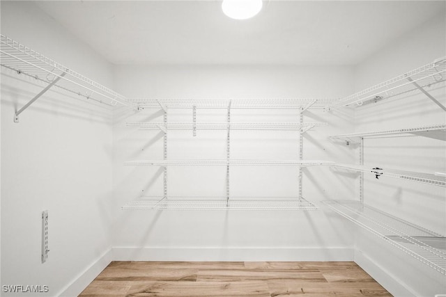 517 Lake Louise Cir Unit 101, Naples, FL 34110 - spacious closet featuring wood finished floors