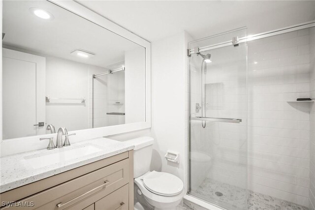 517 Lake Louise Cir Unit 101, Naples, FL 34110 - bathroom featuring toilet, a shower stall, and vanity