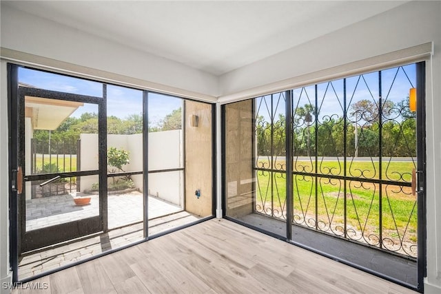 517 Lake Louise Cir Unit 101, Naples, FL 34110 - unfurnished sunroom with wood finished floors