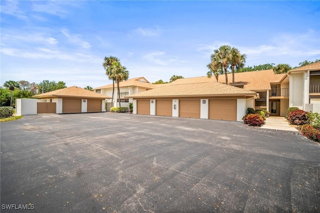 517 Lake Louise Cir Unit 101, Naples, FL 34110 - townhome / multi-family property featuring community garages and stucco siding