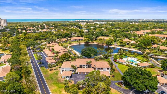 517 Lake Louise Cir Unit 101, Naples, FL 34110 - bird's eye view of a nearby body of water and a pool