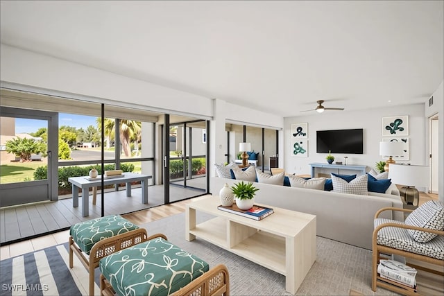 517 Lake Louise Cir Unit 101, Naples, FL 34110 - living area featuring a ceiling fan and light wood-style floors