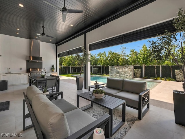 view of patio featuring exterior kitchen, outdoor dining area, a fenced backyard, and an outdoor living space