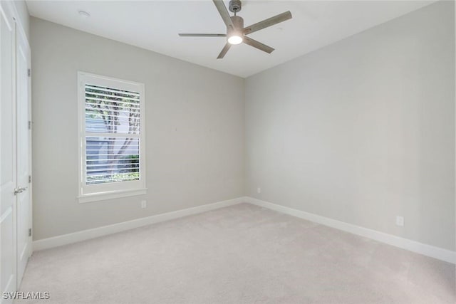 23737 Pebble Pointe Ln, Estero, FL 34135 - spare room with light carpet, a ceiling fan, and baseboards