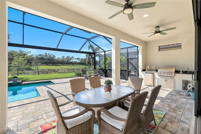 view of patio / terrace featuring ceiling fan, an outdoor pool, area for grilling, exterior kitchen, and a lanai