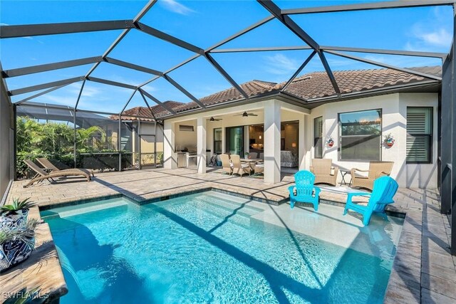 rear view of property featuring a patio, ceiling fan, a tile roof, and stucco siding