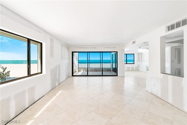 26130 Hickory Blvd Unit 1B, Bonita Springs, FL 34134 - spare room with light tile patterned floors and plenty of natural light
