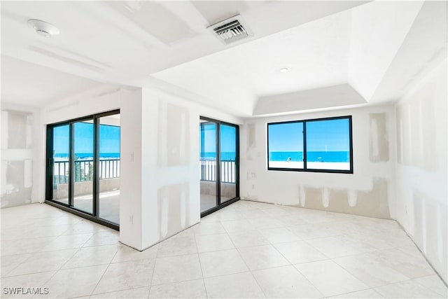 26130 Hickory Blvd Unit 1B, Bonita Springs, FL 34134 - spare room with light tile patterned floors and a raised ceiling