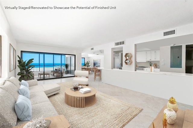 26130 Hickory Blvd Unit 1B, Bonita Springs, FL 34134 - living room with light tile patterned floors and electric panel