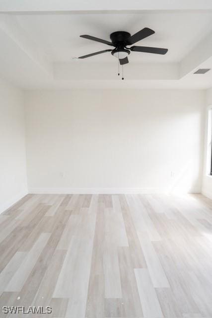1194 Calico St, Labelle, FL 33935 - spare room featuring ceiling fan, a tray ceiling, visible vents, and light wood-type flooring