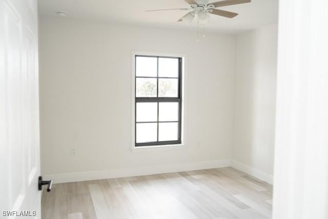 1194 Calico St, Labelle, FL 33935 - empty room with baseboards, a ceiling fan, light wood-style floors, and a healthy amount of sunlight