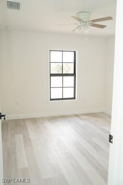 1194 Calico St, Labelle, FL 33935 - unfurnished room with light wood-type flooring, visible vents, a ceiling fan, and baseboards