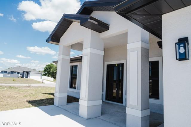 1194 Calico St, Labelle, FL 33935 - view of exterior entry featuring stucco siding