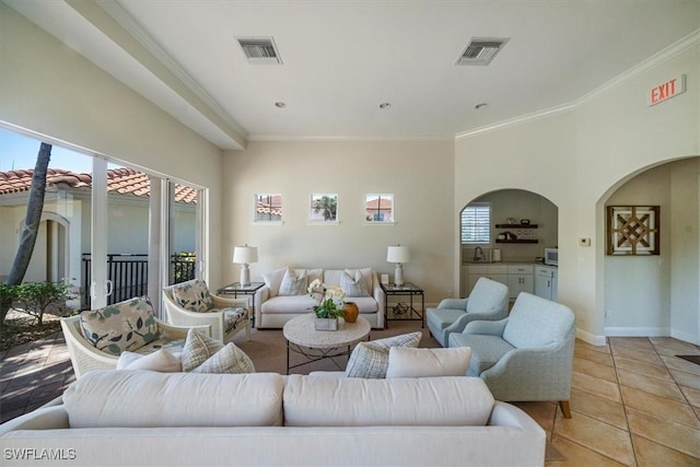 2387 Terra Verde Ln Unit 2387, Naples, FL 34105 - living area featuring visible vents, arched walkways, light tile patterned floors, and crown molding