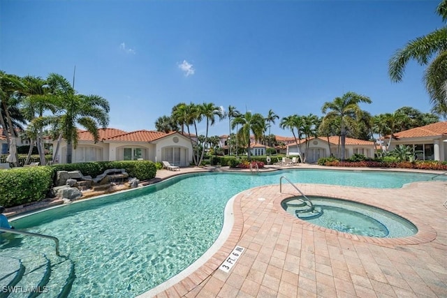 2387 Terra Verde Ln Unit 2387, Naples, FL 34105 - pool with a community hot tub and a patio