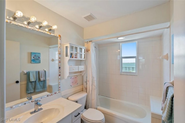 full bathroom featuring toilet, visible vents, shower / tub combo, and vanity
